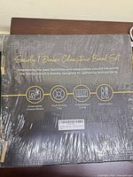 Shrink-wrapped front of Smirly 1-Drawer Charcuterie Board Set box