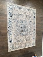 Full view of area rug laid flat showing pattern and colors