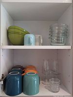 Cabinet with mugs, bowls, wine glasses, prep bowls