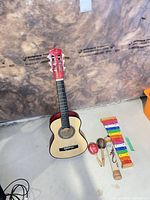 Group shot of guitar, xylophone, maracas, rainstick, mallets