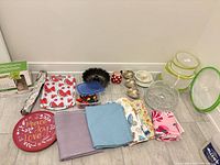 Full lot showing trays, linens, Bundt pan, cake dome, mesh covers, bowls, cups and accessories