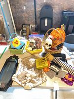 Overview of lot showing gargoyle plaque, mirror, baskets, bowls, picks and assorted decorations