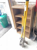 Full view of post hole digger, axes partially visible