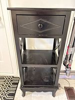 Front view showing drawer and two shelves