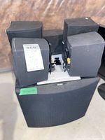 Stack of four Micro90 satellite speakers on top of Micro90c center speaker with brackets visible