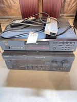 Denon DVD-2200 stacked on Yamaha RX-V595 with remotes and cables visible