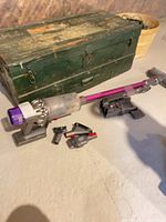 Vacuum with wand, floor head, docking bracket, tools visible