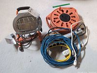 HDX work light, orange cord reel, Noma power bar with cords