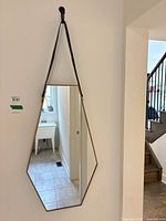 Front view showing mirror shape, frame finish, and strap