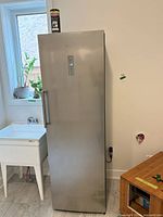 Full front view of Hisense stainless upright freezer/refrigerator showing overall condition and size