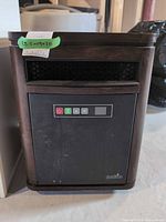 Front view of Duraflame space heater showing cabinet, vent, control panel and casters