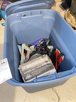 Overall view inside bin showing purple blaster, vests and manual