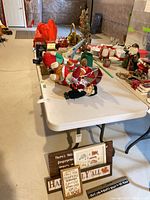 Full lot view with dolls, decorations, signs, table