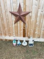 All four items: metal star on fence, two gnomes, cactus planter