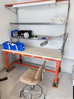 Full view of workbench with stool and lamp