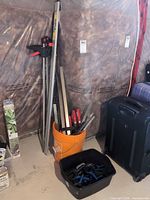 Overall lot showing bar clamps in orange bucket, long Tru-Grip bar, bin of spring clamps