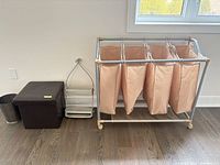 Full view of laundry sorter, storage cube, bathroom caddy and waste bin