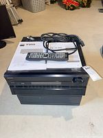 Stacked Onkyo PR-SC885 on NAD T955 with remote, manuals and cables