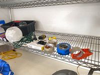 Shelf with assorted tapes, tape measures and jump rope