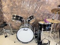 Full view of Pearl black drum kit with cymbals, hardware and throne