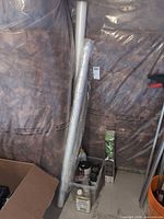 overall lot: rolls of wallpaper/trim, crate with stain, tung oil, small supplies; tropical wallpaper box visible