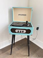 Record player on stand, lid open showing overall appearance