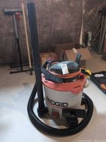 Full view of RIDGID shop vac with hose, extension wand, cord