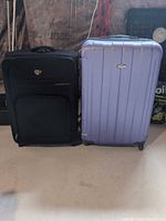Front view of both suitcases showing color, style and size comparison