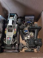 Top view of box showing Tamiya buggy body, separate chassis and Vertex charger