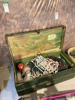 Overall view of open green wooden trunk interior