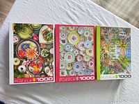 Group view of three Eurographics 1000-piece puzzle boxes