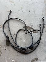 Full view of the black rubber boat fuel line showing primer bulb and both end fittings