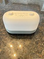 Top view of Dreamegg white noise alarm clock showing control knobs and buttons