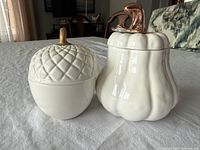 Acorn and pumpkin ceramic containers side by side showing overall appearance