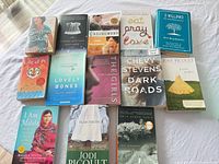 All 13 books laid flat, titles and authors visible