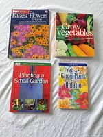 Front covers of four gardening books laid out on surface