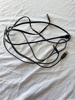 Tangled view showing both cables with USB-A and power cord ends visible