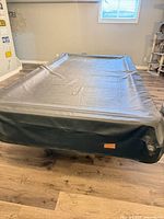 Pool table with black vinyl cover