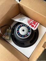 Pyle 10-inch subwoofer in box with crossover and manual visible