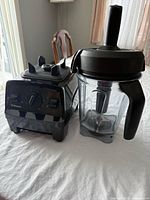 Motor base and 2-L jar with lid and tamper side by side