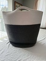 Front view of two-tone rope basket showing color, texture, and handles
