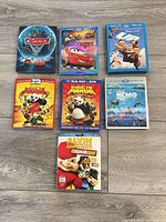 Front covers of seven Blu-ray + DVD combo movie cases