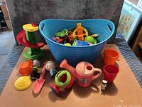 overall lot showing tub, watering cans, shovel, figurines, cups, slide piece