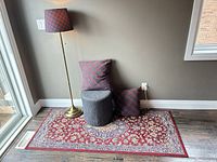 Group shot showing lamp, pillows, stool, rug