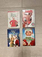 All four DVD fronts displayed on floor tile