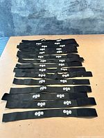 Full set of 15 black ege logo straps laid flat