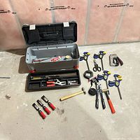 Overall lot layout with toolbox, tray, clamps, hammers and accessories