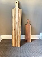 Both paddle boards standing for size comparison