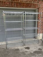 Both shelving units standing side by side showing full height and shelf count