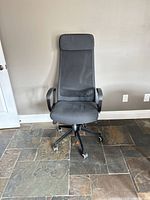 Front view of chair showing mesh back, fabric seat, base and casters